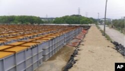 Temporary storage tanks for low and middle level radioactive water from Tokyo Electric Power (TEPCO) Co.'s Fukushima Daiichi Nuclear Power Station's No.1, No.2, No.3 and No.4 reactors are seen at the grounds of the plant in Fukushima prefecture, June 5, 2