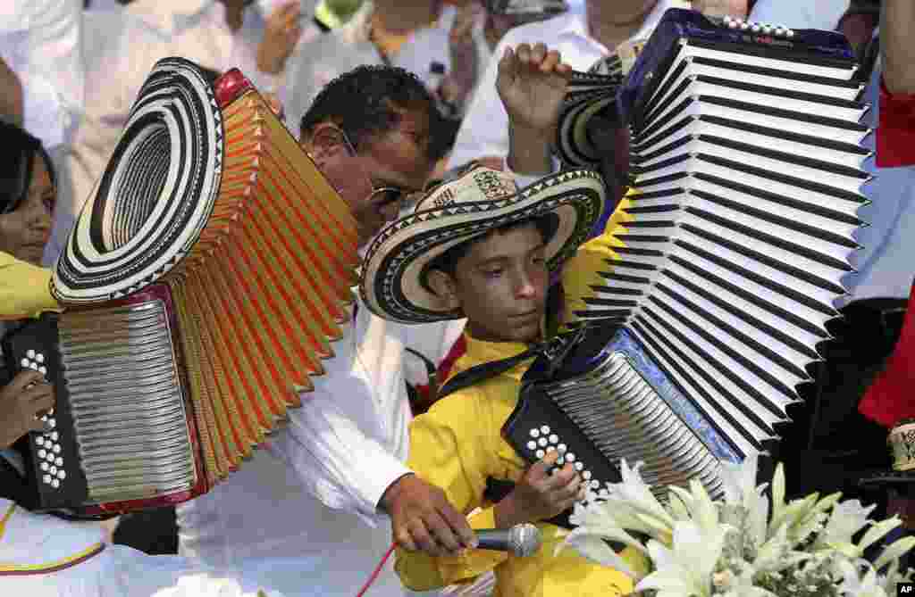 A boy plays the accordion during a musical homage to singer and composer Diomedes Diaz at the main square of Valledupar, in Colombia's northern state of Cesar, Dec. 25, 2013. Diomedes Diaz, one of the greatest performers of the country's accordion vallenato music, died on Dec. 22, 2013, at age 56.