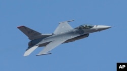 FILE- A U.S. F-16 performs during the Aero India 2017 in Bangalore, India, Feb. 16, 2017. The Trump administration told Congress Wednesday that it plans to approve a multibillion-dollar sale of F-16 fighter jets to Bahrain without the human rights conditions imposed by the Obama administration.