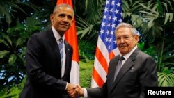 U.S. President Barack Obama and Cuba's President Raul Castro shake hands during their first meeting on the second day of Obama's visit to Cuba, in Havana, March 21, 2016.