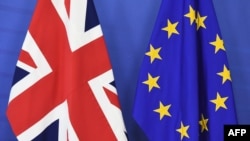 FILE - British and EU flags are set up ahead of British Prime Minister David Cameron's visit at the European Commission, Brussels, Jan. 29, 2016.