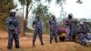 FILE - A line of riot police prevent the media and others from approaching Uganda's main opposition leader Kizza Besigye, who was placed under house arrest at his home in Kasangati, Uganda, Feb. 22, 2016. 