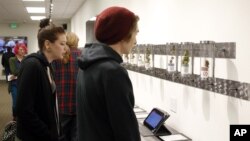 Customers look at product displays at Shango Premium Cannabis, in Portland , Oregon, Oct. 1, 2015. 