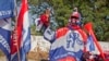 FILE - A supporter of the New Patriotic Party wears campaign paraphernalia on the side of a road in Accra, Ghana, Nov. 23, 2012. The election for Ghana's next president will be held December 7.