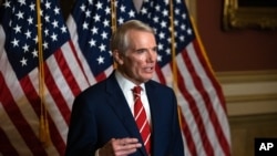 FILE - This Monday, Oct. 26, 2020, file photo shows Sen. Rob Portman, R-Ohio, speaking during a news conference in Washington. Portman is participating in a COVID-19 vaccine study.