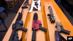 FILE - This Nov. 27, 2019, photo shows "ghost guns" on display at the headquarters of the San Francisco Police Department in San Francisco. 
