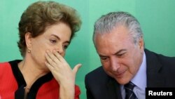 FILE - Brazil's President Dilma Rousseff (L) talks to Vice President Michel Temer at the Planalto Palace in Brasilia, Brazil, March 2, 2016.