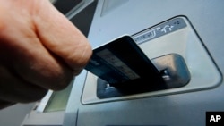 FILE - Law enforcement officials say Ercan Findikoglu hacked into credit card company computers and allowed members of a global gang to make thousands of fraudulent ATM withdrawals. 