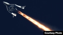 FILE - Virgin Galactic's SpaceShipTwo is seen flying over the Mojave Desert in California in September 2014.