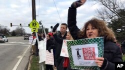Su Sheridan holds a sign protesting proposed cuts to retirement benefits for public school teachers, March 8, 2018 in Frankfort, Kentucky.