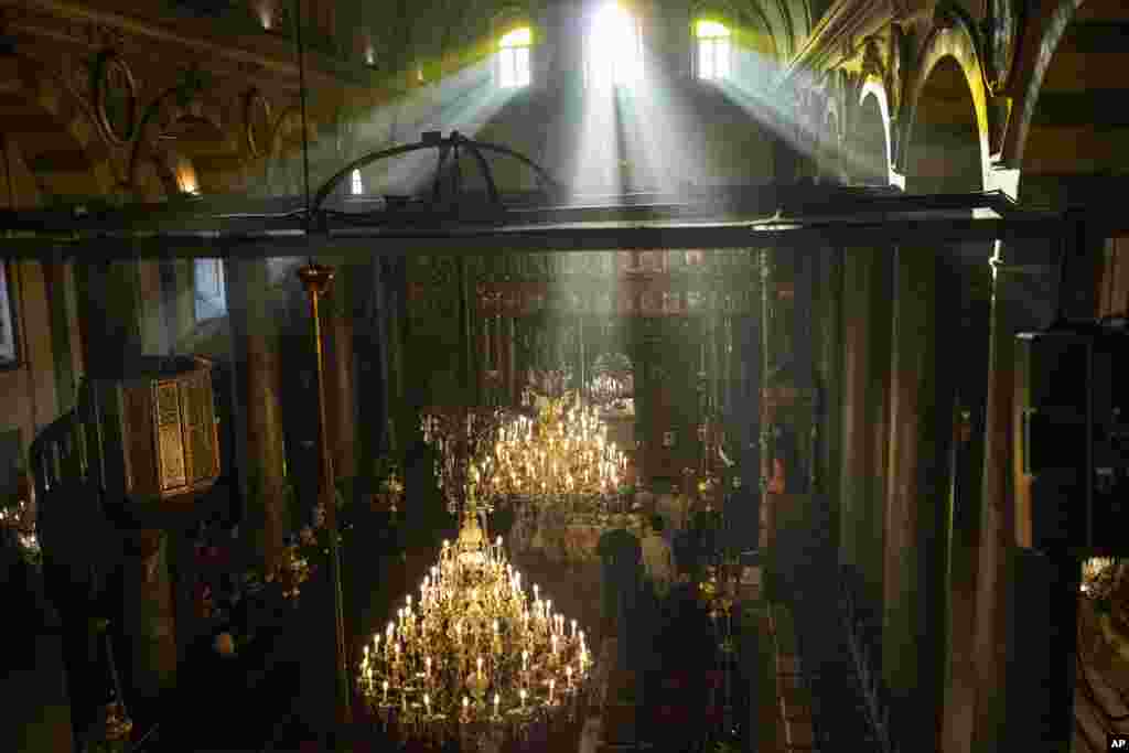 Ecumenical Patriarch Bartholomew I, the spiritual leader of the world's Orthodox Christians, right, leads the Epiphany Mass at the Patriarchal Church of St. George in Istanbul, Turkey.