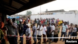 People wait to vote during the presidential election at a polling station in Monrovia, Liberia, Dec. 26, 2017. 