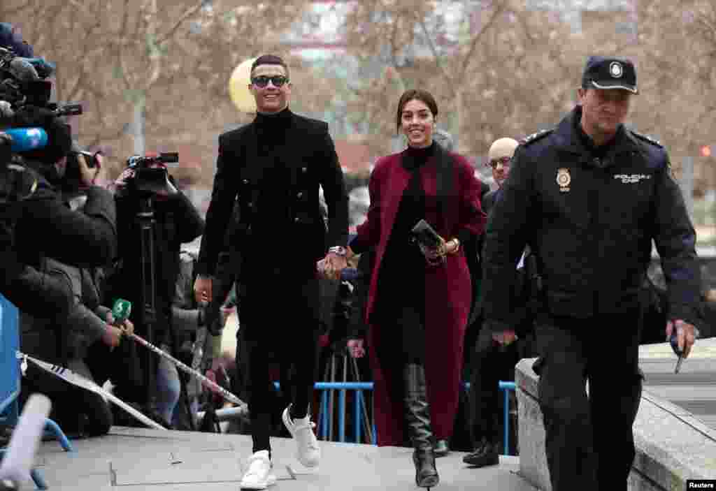 Portugal's soccer player Cristiano Ronaldo arrives with his girlfriend Georgina Rodriguez to appear in court on a trial for tax fraud in Madrid, Spain.