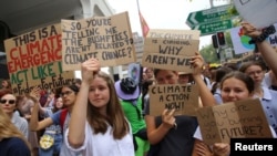 Student activists from School Strike for Climate Australia (SS4C) hold a "Solidarity Sit-down" outside the office of the Liberal Party of Australia in Sydney, Nov. 29, 2019.