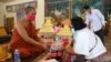 ពុទ្ធបរិស័ទកំពុង​ប្រគេន​ទេយ្យទាន​ដល់​ព្រះ​សង្ឃ​​ក្នុង​វត្ត​និរោធ​រង្សី រាជធានី​ភ្នំពេញ ក្នុង​អំឡុង​​ពេល​​ប្រារព្ធ​ពិធី​បុណ្យ​ចូល​ឆ្នាំ​ខ្មែរ​ថ្ងៃទី​២ នៅ​ថ្ងៃ​ទី​១៤ ខែមេសា ឆ្នាំ​២០២០។ (កាន់ វិច្ឆិកា/VOA)​​