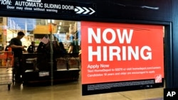 FILE - A hiring sign is displayed at a retail store in Mount Prospect, Illinois, Nov. 2, 2024. The U.S. Labor Department reported on March 7, 2025, that employers added 151,000 jobs in February.