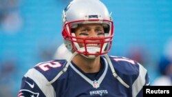 FILE - New England Patriots quarterback Tom Brady (12) stands on the field during warm ups prior to the game against the Carolina Panthers at Bank of America Stadium, Charlotte, North Croloina, Aug 26, 2016.