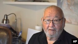 In this Wednesday, Nov. 13, 2019, photo, Kiowa writer N. Scott Momaday, who won a Pulitzer Prize in 1969 for his groundbreaking novel "House Made of Dawn," sits in his Santa Fe, N.M., home between writing sessions.