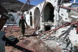 A soldier walks at the site of a Houthi missile attack on a military camp’s mosque in Marib, Yemen, Jan. 20, 2020.