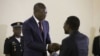  Patrice Talon recevant le rapport des mains du président de la commission, le ministre de la justice Joseph Djogbenou.
