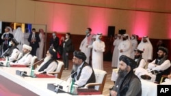 Members of the Taliban delegation are seen at the opening session of peace talks between the Afghan government and the Taliban, in Doha, Qatar, Sept. 12, 2020. 