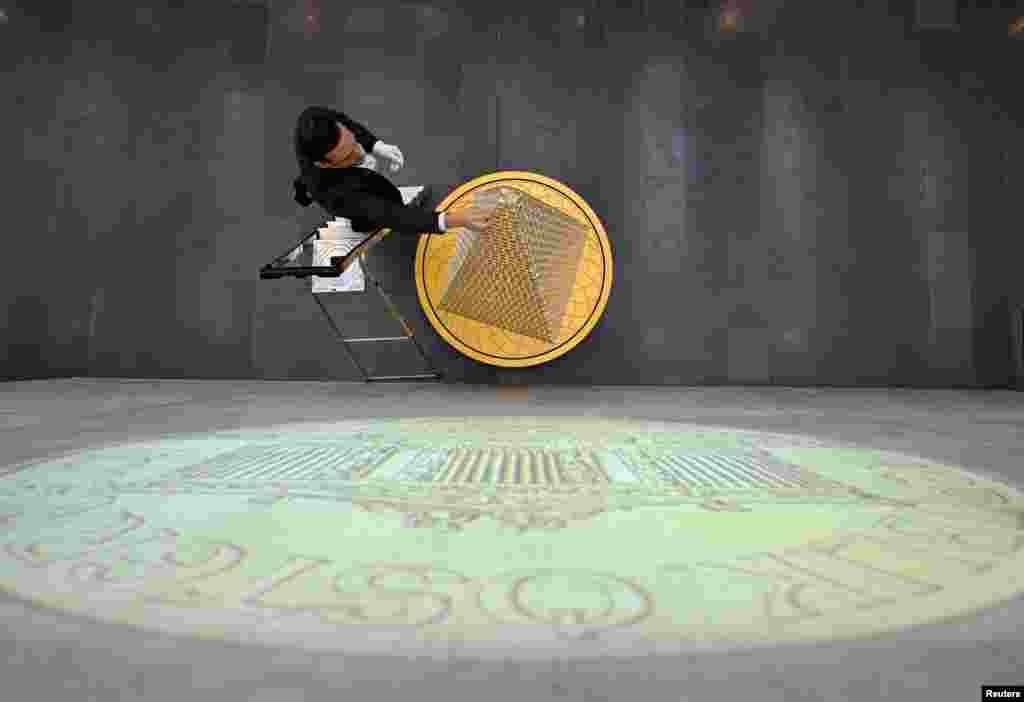 Benjamin Summa, press spokesman from "pro aurum," puts down a mint in collaboration with the Austrian mint. The precious metal dealer "pro aurum" presents almost a 3-meter gold tree consisting of 2,024 Vienna Philharmonic coins, which has a value of more than 5 million euros and is not for sale, in Munich, Germany.
