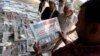FILE - A man reads El-Watan newspaper at Tahrir square in Cairo, Egypt. 