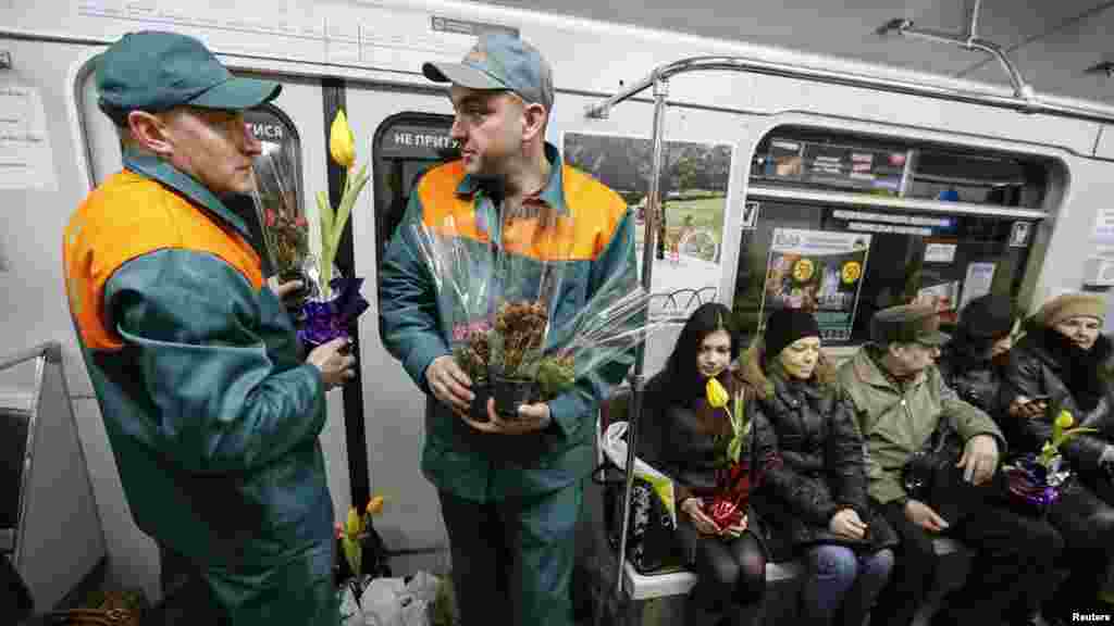 Kyiv's subway staff waits for female passengers in order to offer them flowers ahead of International Women's Day in Kyiv, Ukraine, March 2, 2016.