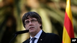 Catalan regional President Carles Puigdemont addresses the media in Barcelona, Spain, Oct. 15, 2017. 