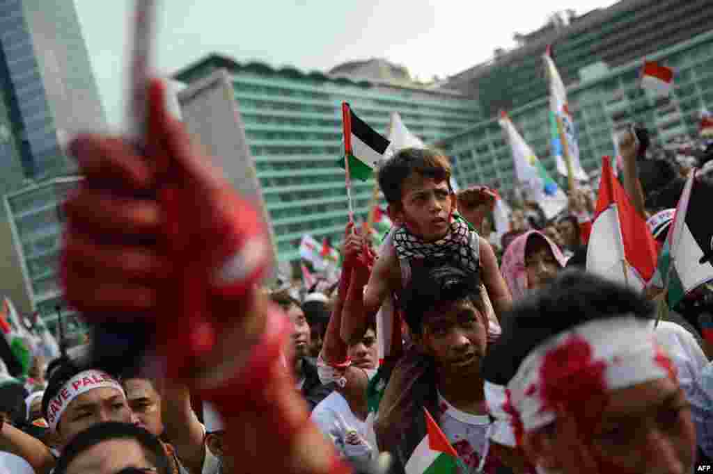 Indonesian demonstrators, some splashed with red paint, stage a huge pro-Palestinian rally in Jakarta condemning Israel's offensive in Gaza.