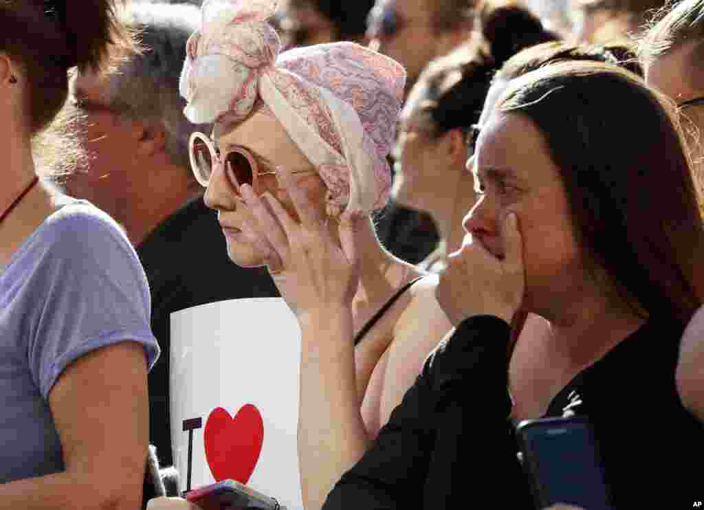 People attend a vigil in Albert Square, Manchester, England, May 23, 2017, the day after the suicide attack at an Ariana Grande concert that left 22 people dead as it ended on Monday night.