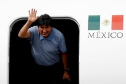 Former Bolivian President Evo Morales waves upon arrival to Mexico City, Nov. 12, 2019.