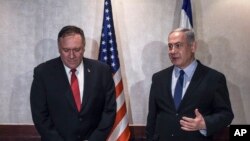 Israeli Prime Minister Benjamin Netanyahu, right, and U.S. Secretary of State Mike Pompeo speak during their meeting in Lisbon, Dec. 4, 2019.