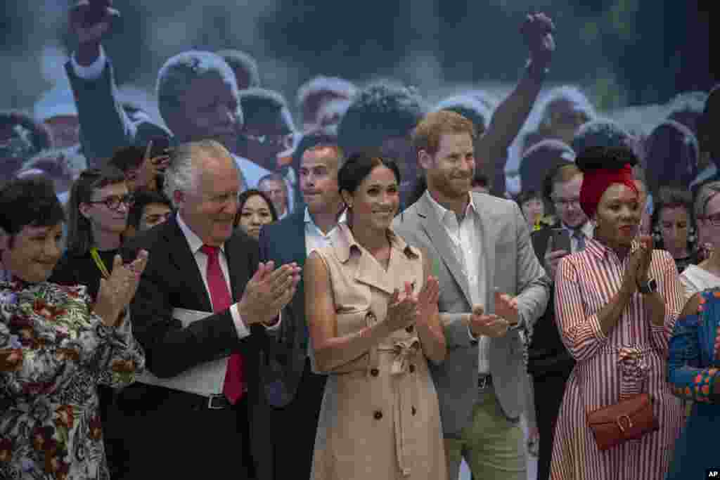 Britain's Prince Harry, second right, and Meghan, the Duchess of Sussex, attend the launch of the Nelson Mandela Centenary Exhibition, marking the 100th anniversary of the anti-apartheid leader's birth, at the Queen Elizabeth Hall in London.