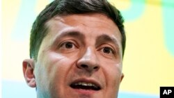 FILE - Ukrainian President Volodymyr Zelenskiy speaks to reporters in Kyiv, Ukraine,July 21, 2019. 