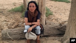 Well-known Tibetan writer Tsering Woeser poses for a photo in Inner Mongolia in northern China, June 23, 2014.