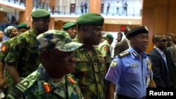 FILE: Nigerian mlitary officials are consulting with Sri Lanka on tactics that country used to overcome terrorists. Here, Nigerian Gen. Kenneth Minimah and guards leave a meeting in Abuja on May 15, 2014.