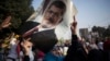 An Egyptian woman holds a portrait of ousted Egyptian President Mohamed Morsi during a protest in Nasr City in Cairo, Nov. 1, 2013.