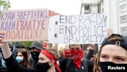 FILE - Activists of an LGBT community and human rights organizations take part in a protest against police brutality demanding the resignation of Ukrainian Interior Minister Arsen Avakov, in Kyiv, Ukraine, June 5, 2020. 