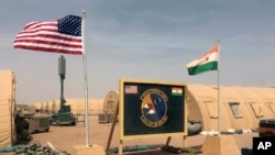 FILE - U.S. and Niger flags fly at the Niger Air Base 201 in Agadez, Niger, April 16, 2018. 