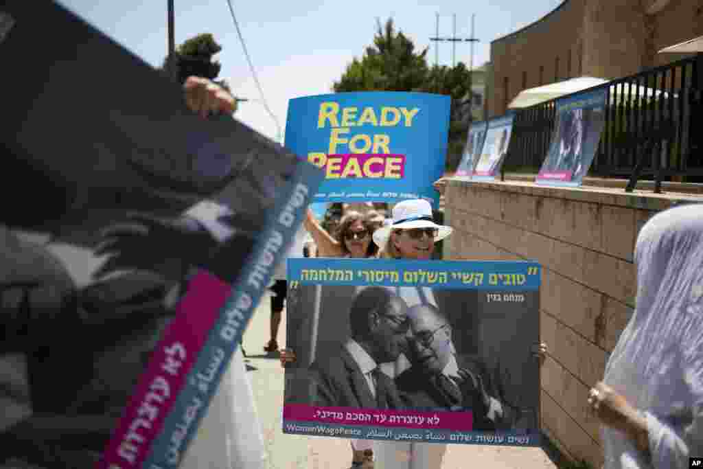 Activists hold posters as U.S. President Donald Trump arrives in Jerusalem, May 22, 2017.
