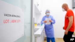 A door sign shows the batch of AstraZeneca vaccine currently used at a vaccination center in Bucharest, Romania, April 7, 2021.
