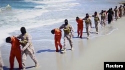 FILE - Islamic State militants lead what are said to be Ethiopian Christians along a beach in Wilayat Barqa, in this still image from an undated video made available on a social media website on April 19, 2015.