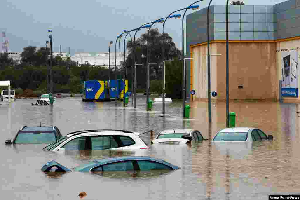 Cars are submerge in a flooded parking lot outside a shopping center in Oman's capital Muscat. Bad weather has been affecting states around the Gulf, with several issuing weather warnings.
