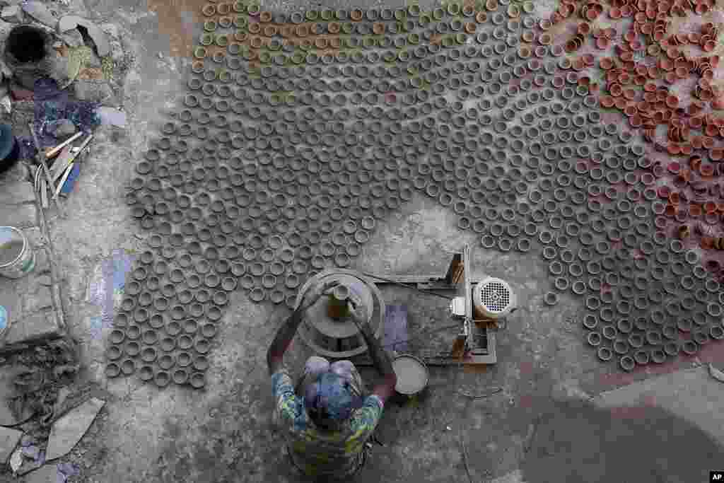 A potter makes earthen lamps ahead of Diwali, the festival of lights, in Ahmedabad, India.