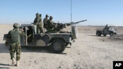 Afghan National Army soldiers guard at a checkpoint on the way to the Sangin district of Helmand province, Afghanistan, Wednesday, Dec. 23, 2015.