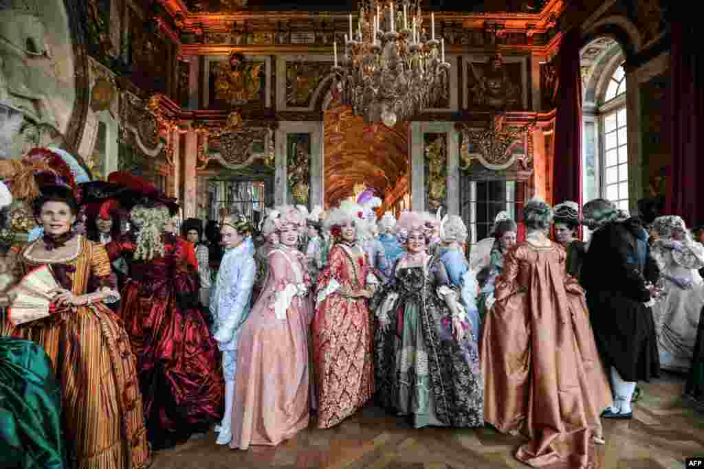 People dressed in period costumes take part in the "Fetes Galantes" fancy dress evening at the "galerie des glaces" in the Chateau de Versailles, France, May 27, 2019.