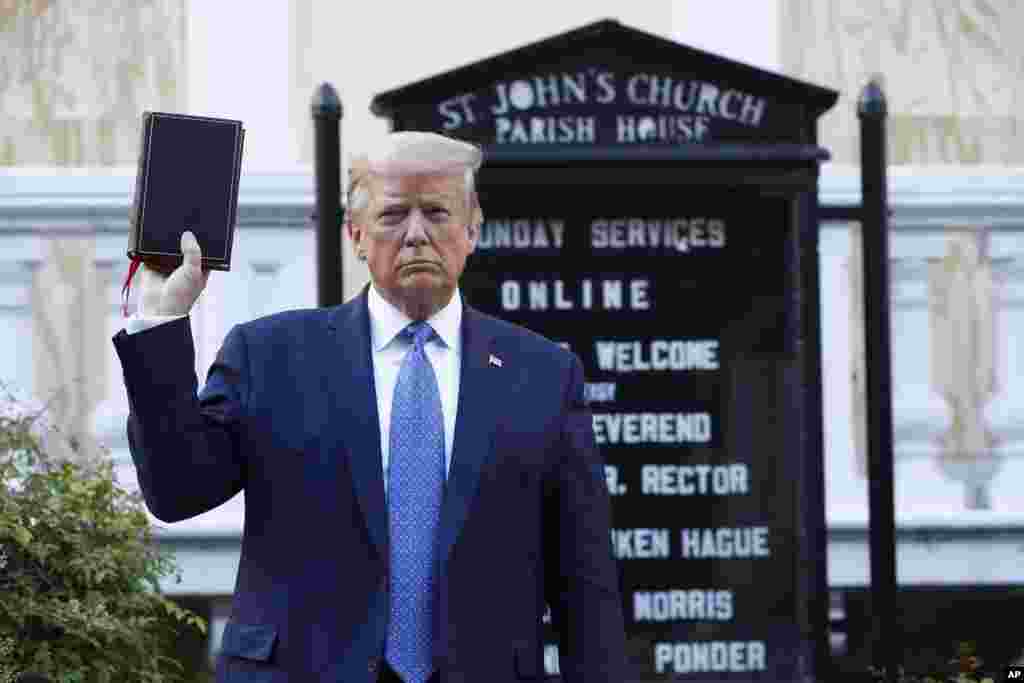 President Donald Trump holds a Bible as he visits outside St. John's Church across Lafayette Park from the White House, June 1, 2020, in Washington. Park of the church was set on fire during protests on Sunday night.