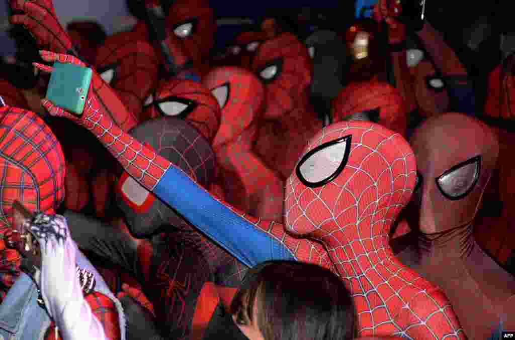 Fans dressed in Spider-Man outfits gather at a promotional event for the forthcoming "Spider-Man: Homecoming" movie at the Art Science Museum in Singapore.