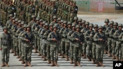 Chinese military personnel line up during the Golden Dragon military exercise in Svay Chok village, Kampong Chhnang province, north of Phnom Penh, Cambodia, May 30, 2024.